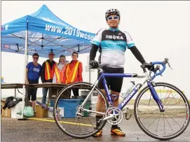  ??  ?? Volunteers under the tent from left to right ( Guylaine Green, Office Manager for Games, Matt Doerksen of Herbert, Karley Patenaude of Swift Current, Payton Grodaes of Abbey Cyclist Michael Salcedo is a local competitor.