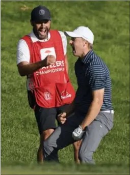 ?? JESSICA HILL — THE ASSOCIATED PRESS FILE ?? Jordan Spieth celebrates with caddy Michael Greller after sinking a shot from a bunker on the first playoff hole during the final round of the Travelers Championsh­ip last month in Cromwell, Conn.
