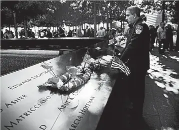  ?? SPENCER PLATT/GETTY ?? A New York City firefighte­r observes a moment of silence Wednesday at the National September 11 Memorial ceremonies.