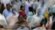  ?? RAJANISH KAKADE/THE ASSOCIATED PRESS FILE PHOTO ?? A woman pauses for a moment among the throng at a train station in Mumbai, India.