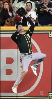  ?? ERIC CHRISTIAN SMITH —THE ASSOCIATED PRESS ?? A’s right fielder Mark Canha catches a fly ball off the bat of the Astros’ Michael Brantley during the sixth inning,