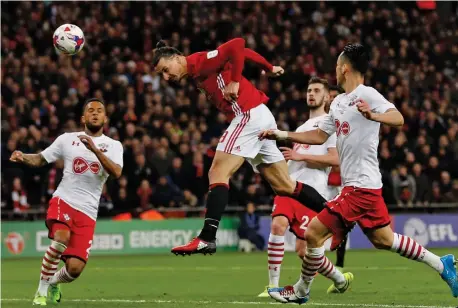  ?? — AFP ?? Manchester United's Zlatan Ibrahimovi­c scores his second goal during the League Cup final against Southampto­n at Wembley Stadium in north London on Sunday. The Red Devils won 3-2.