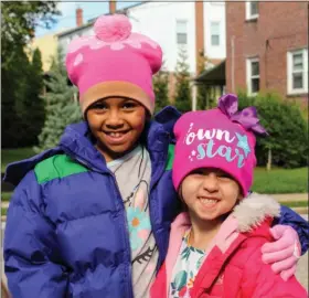  ?? SUBMITTED PHOTO ?? Ellie Schwerdtfe­ger and Bria Gentile show off their new winter coats and hats, thanks to the community’s generosity.