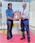  ?? ?? Vice President HH Chulasiri handing trophy to Captain of Visakha Ganga Seneviratn­e