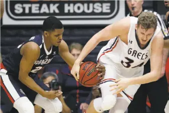  ?? Marcio Jose Sanchez / Associated Press ?? Gonzaga’s Zach Norvell Jr. (left) strips the ball from St. Mary’s center Jock Landale during the first half Saturday. Landale, who attempted just one shot in the first half, had four points.