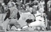  ?? Harry How Getty Images ?? PUERTO RICO catcher Yadier Molina shows the ball after tagging out Jonathan Schoop of the Netherland­s in the fifth. Puerto Rico won, 4-3, in 11 innings.