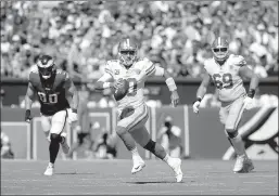  ?? Tim Hawk
/ TNS ?? San Francisco 49ers QB Jimmy Garoppolo (10) runs for a first down vs. the Philadelph­ia Eagles during the second quarter at Lincoln Financial Field on Sunday.