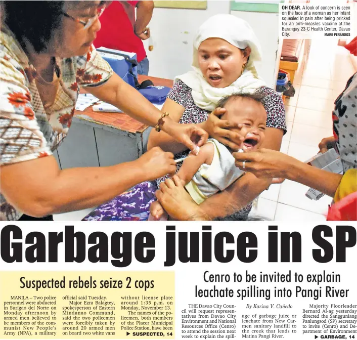  ?? MARK PERANDOS ?? OH DEAR. A look of concern is seen on the face of a woman as her infant squealed in pain after being pricked for an anti-measles vaccine at the Barangay 23-C Health Center, Davao City.