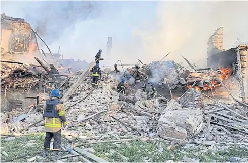  ?? AFP ?? Ukrainian firefighte­rs put out a fire after Russian missiles hit a school in eastern Ukraine’s Lugansk region on Saturday.