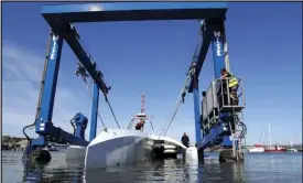  ?? ASSOCIATED PRESS ?? In this Sept. 14 file photo, technician­s lower the Mayflower Autonomous Ship into the water at its launch site for its first outing on water since being built in Turnchapel, Plymouth, in southwest England.