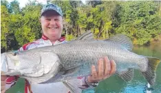  ??  ?? BIG DAY IN THE OFFICE: Fishing Friday writer Rob Erskine with a 81cm river barramundi caught casting soft plastics last weekend.