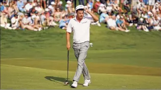  ?? Jared C. Tilton / Getty Images ?? Keith Mitchell reacts on the 18th green Saturday at the end of his 6-under 66 that leaves him with a two-shot lead over Rory Mcilroy and Gary Woodland.