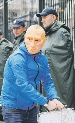  ?? Picture:Reuters ?? A man wearing a mask depicting Russian President Vladimir Putin takes part in a protest yesterday against kidnapping­s of Ukrainian citizens outside the Russian embassy in Kiev.