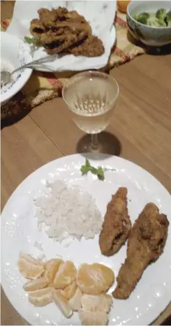  ?? | DALE BOWMAN/ FOR THE SUN- TIMES ?? Perch dinner plated with basmati rice and clementine slices with a fresh parsley garnish.