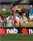  ?? Photograph:
Michael Willson/AFL Media/Getty Images ?? Tayla Harris’s famous kick that has now
been immortalis­ed in bronze.