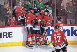  ?? SEEGER GRAY/USA TODAY ?? Blackhawks center Connor Bedard, center, celebrates with teammates after scoring a goal vs. the Dallas Stars on Saturday in Chicago.