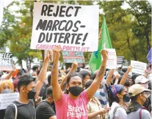  ?? AP-Yonhap ?? A protester holds a slogan during a rally in front of the office of the Commission on Elections as they question the results of the presidenti­al elections in Manila, Philippine­s, Tuesday.