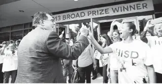  ?? Mayra Beltran / Houston Chronicle file ?? HISD Superinten­dent Terry Grier greeted Alicia McAfee as students, teachers and administra­tors gathered to celebrate after the district won the 2013 Broad Prize for Top Urban Education.