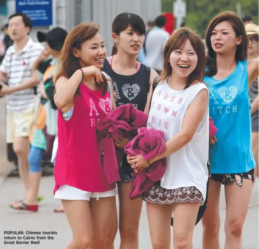  ??  ?? POPULAR: Chinese tourists return to Cairns from the Great Barrier Reef.