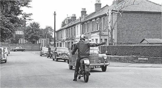  ?? ?? Another shot from Mortons Archive shows a staffman correctly positioned in the road and giving a clear hand signal that he intends to turn right as he waits for the oncoming traffic to pass.