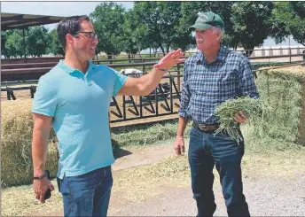  ?? PHOTO FROM FACEBOOK ?? Republican U.S. Senate candidate Mark Ronchetti meets with a New Mexico dairy farmer in July.