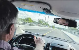  ?? ANDREJ IVANOV WATERLOO REGION RECORD ?? Regional Chair Ken Seiling drives the first vehicle across the new Fountain Street bridge.