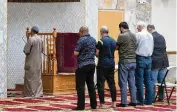  ?? PIERRE-LOUIS/ALBUQUERQU­E JOURNAL VIA AP ADOLPHE ?? An Imam leads the Dhuhr afternoon prayer at the Islamic Center of New Mexico in Albuquerqu­e, after the fourth Muslim man was murdered in the city.