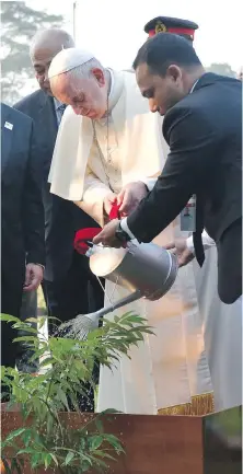  ?? L'OSSERVATOR­E ROMANO/POOL PHOTO VIA AP ?? Pope Francis waters a plant at the Garden of Peace at the National Martyr's Memorial of Savar, in Dhaka, Bangladesh, on Thursday.
