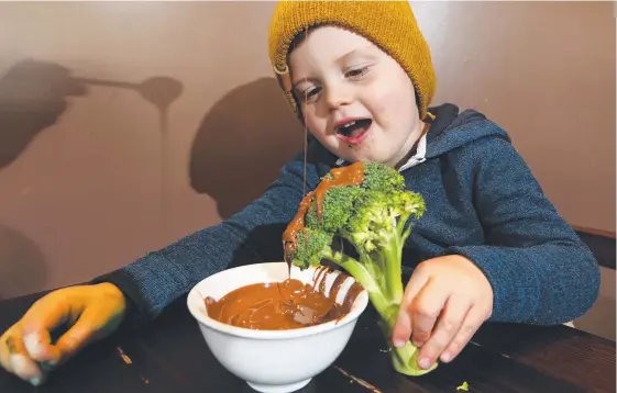  ?? Picture: GLENN HAMPSON ?? Bowen Dawson, 3, sweetens his broccoli with a chocolate drizzle at the Max Brenner Chocolate Bar in Robina Town Centre.