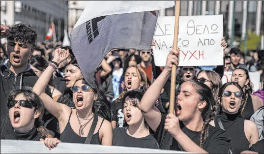  ?? Petros Giannakour­is The Associated Press ?? University students chant slogans Friday during a protest march to the Athens headquarte­rs of private operator Hellenic Train.