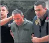  ??  ?? HELD: A member of Turkey’s armed forces is escorted away by police.