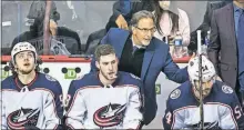  ?? [DARRYL DYCK/THE CANADIAN PRESS] ?? Coach John Tortorella pats Adam Mcquaid on the back as he sits on the bench with Artemi Panarin, left, and Pierreluc Dubois during the Jackets’ 5-0 win over the Canucks on Sunday night.