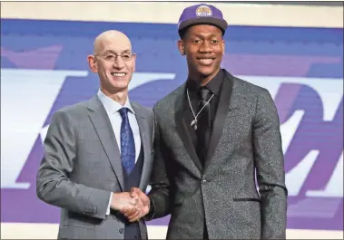  ?? AP-Julio Cortez, File ?? Virginia’s De’Andre Hunter (right) is greeted by NBA Commission­er Adam Silver after being selected with the fourth pick overall by the Los Angeles Lakers during the NBA basketball draft in New York. Hunter went No. 4 overall.