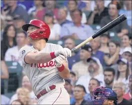  ?? CHARLES REX ARBOGAST – THE ASSOCIATED PRESS ?? Rhys Hoskins of the Phillies slugs a two-run double off Cubs starter Jake Arrieta during the second inning as part of a four-RBI performanc­e Tuesday night at Wrigley Field.