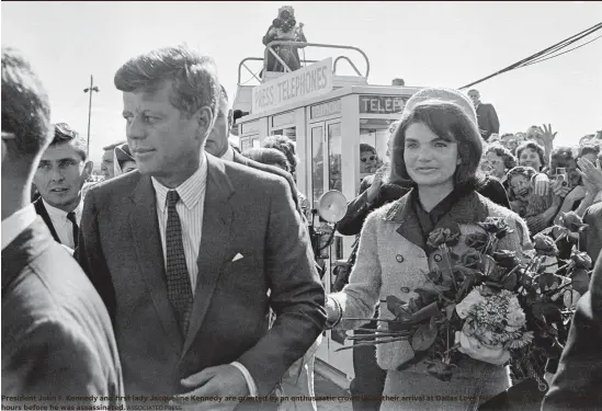  ?? ASSOCIATED PRESS ?? President John F. Kennedy and first lady Jacqueline Kennedy are greeted by an enthusiast­ic crowd upon their arrival at Dallas Love Field on Nov. 22, 1963, only a few hours before he was assassinat­ed.