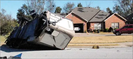  ?? Marc Hayot/Herald-Leader ?? A recreation­al vehicle owned by Matt Younkin, who lives in the Stonecrest Subdivisio­n, was flipped over by the storm during the early hours of Monday morning.