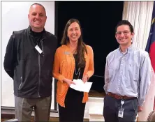  ?? PHOTO SPECIAL TO THE O-N-E ?? Lorissa Vines, Carolina Caring Foundation’s Director of Developmen­t accepts a grant from local Rotary Club Presidents Kelly Farr and Dave Leonetti to help grieving children.