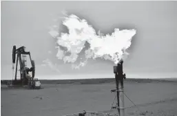  ?? MATTHEW BROWN/AP ?? A flare burns natural gas at an oil well Aug. 26 in Watford City, N.D. Consumers of natural gas are facing the prospect of much higher heating bills this winter.