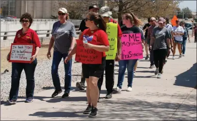  ?? The Associated Press ?? SCHOOL FUNDING: Teachers and supporters walk around the state Capitol as part of protests over school funding Thursday in Oklahoma City. The walkout that shuttered schools in many of Oklahoma’s largest districts for two straight weeks came to an end on...