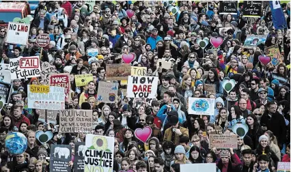  ?? MELISSA RENWICK THE CANADIAN PRESS FILE PHOTO ?? Thousands of people took to the streets joining in a climate strike which Greta Thunberg attended, in Vancouver last month. A new report says a baby born in Canada today will never know a time which their health isn’t at risk from climate change.