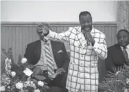  ?? PHOTOS BY ARIEL COBBERT/COMMERCIAL APPEAL ?? Walmart employee Wallace Daley sings at the Saturday funeral for Gales. Gales died on July 30 after being shot while at work.