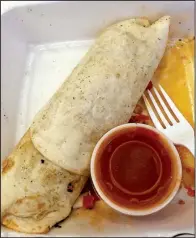  ?? Arkansas Democrat-Gazette/JENNIFER CHRISTMAN ?? The Chorizo Burrito is a lunchtime specialty at Luncheria Mexicana Alicia, which sometimes serves breakfast, at The Food Truck Stop @ Station 801 in downtown Little Rock.