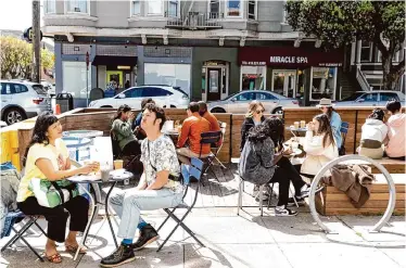  ?? Laura Morton/Special to The Chronicle ?? Breadbelly patrons eat lunch in the cafe’s popular parklet in the Richmond District in 2022.