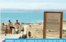  ??  ?? SWEIMEH, Jordan: A sign marking the level of the Dead Sea in 2005 is seen near this village on March 11, 2018. — AFP