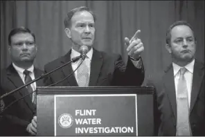  ?? AP/JAKE MAY ?? In charging the six state employees, Michigan Attorney General Bill Schuette said Friday in Flint, Mich., that each tried to “bury or cover up” the truth about the lead contaminat­ion of the city’s water.