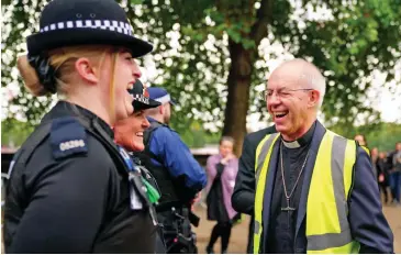  ?? ?? Relaxed: Archbishop of Canterbury Justin Welby shares a joke with police officers