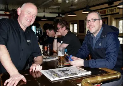  ??  ?? Publican Liam Sinnott in Sinnott’s Bar, Distillery Road, on Good Friday with customer JP Carroll.