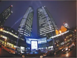  ?? (Ralph Orlowski/Reuters) ?? THE HEADQUARTE­RS of Deutsche Bank is spotlighte­d during an opening ceremony in Frankfurt in 2011.