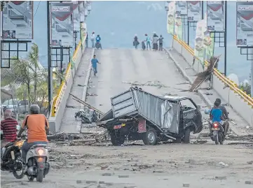  ?? Picture: CARL COURT/GETTY ?? Scene of devastatio­n at the foot of a bridge in Palu yesterday after the tsunami struck the city