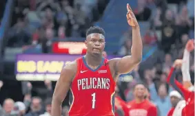  ?? Gerald Herbert, The Associated Press ?? New Orleans forward Zion Williamson reacts after making a 3-point basket in his debut against San Antonio on Wednesday.
